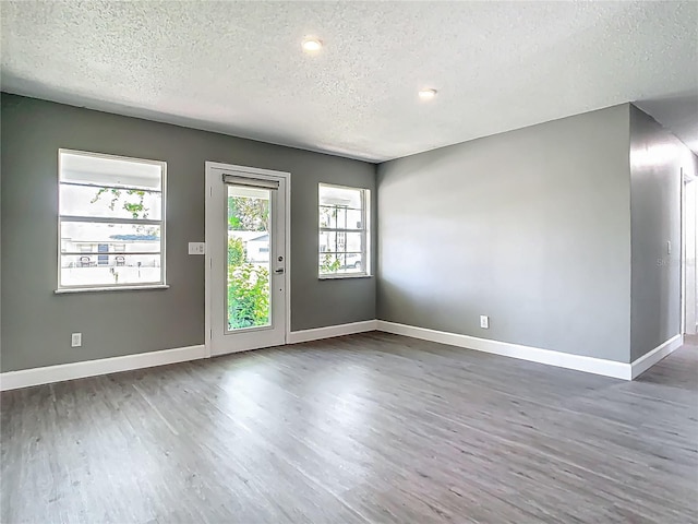 8228 Shriver Dr, Orlando, FL 32822 - spare room featuring a textured ceiling, wood finished floors, baseboards, and recessed lighting