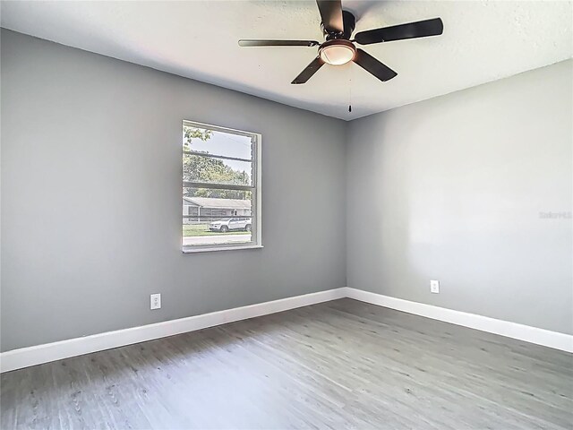 8228 Shriver Dr, Orlando, FL 32822 - spare room featuring wood finished floors, baseboards, and a ceiling fan