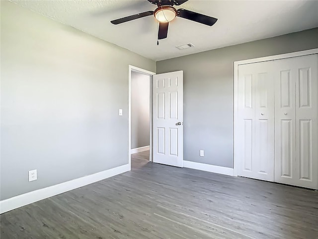 8228 Shriver Dr, Orlando, FL 32822 - unfurnished bedroom with wood finished floors, baseboards, a closet, and a ceiling fan