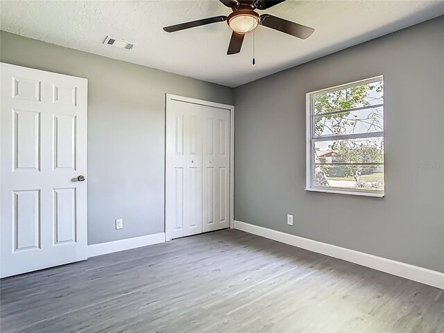 8228 Shriver Dr, Orlando, FL 32822 - unfurnished bedroom featuring wood finished floors, baseboards, a closet, and ceiling fan