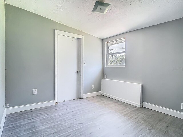 8228 Shriver Dr, Orlando, FL 32822 - unfurnished room featuring wood finished floors, a textured ceiling, and baseboards
