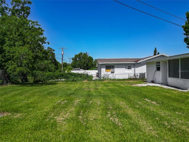 8228 Shriver Dr, Orlando, FL 32822 - view of yard with a sunroom