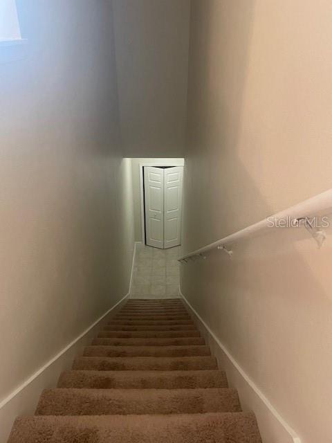 417 Southern Pecan Cir Unit 201, Winter Garden, FL 34787 - stairway featuring baseboards