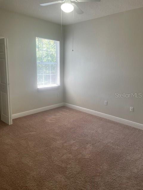 417 Southern Pecan Cir Unit 201, Winter Garden, FL 34787 - empty room with light colored carpet, a ceiling fan, and baseboards