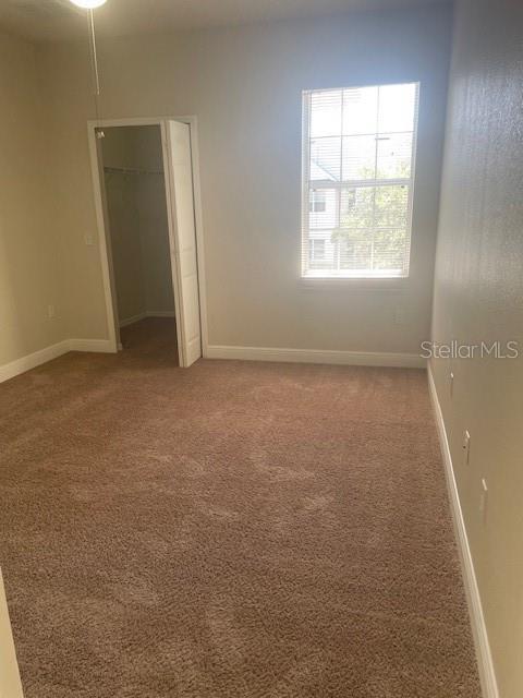 417 Southern Pecan Cir Unit 201, Winter Garden, FL 34787 - empty room featuring light carpet and baseboards