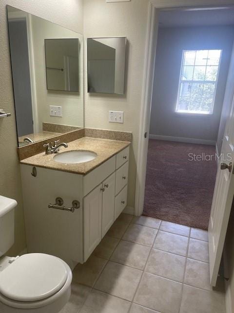 417 Southern Pecan Cir Unit 201, Winter Garden, FL 34787 - bathroom featuring tile patterned flooring, toilet, and vanity