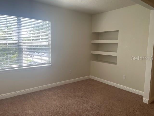 417 Southern Pecan Cir Unit 201, Winter Garden, FL 34787 - carpeted empty room with baseboards