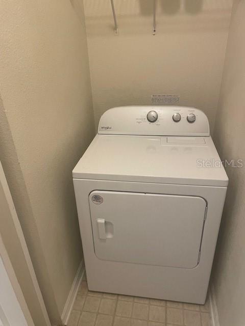 417 Southern Pecan Cir Unit 201, Winter Garden, FL 34787 - laundry room with washer / dryer and baseboards
