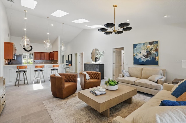 living area featuring a skylight and high vaulted ceiling