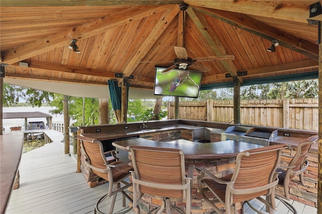 deck featuring fence, a ceiling fan, a gazebo, and a sink
