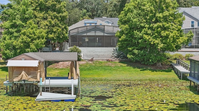 dock area with boat lift, a lanai, and a water view