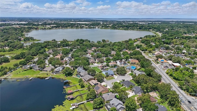 aerial view of residential area featuring a large body of water