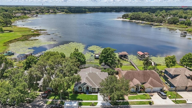 aerial view of residential area featuring a large body of water