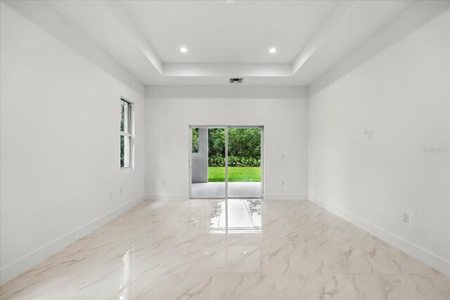 4528 Yorkshire Ln, Kissimmee, FL 34758 - unfurnished room with marble finish floors, a tray ceiling, baseboards, and recessed lighting