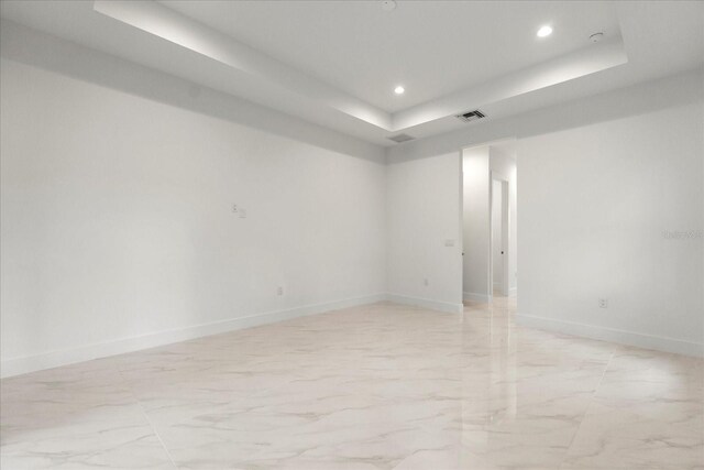 4528 Yorkshire Ln, Kissimmee, FL 34758 - unfurnished room with a raised ceiling, recessed lighting, baseboards, and light marble finish floors