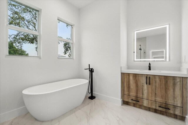 4528 Yorkshire Ln, Kissimmee, FL 34758 - full bathroom with baseboards, a soaking tub, plenty of natural light, and vanity