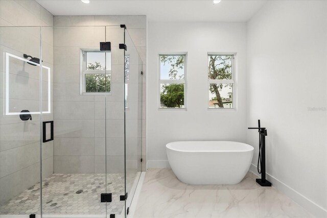 4528 Yorkshire Ln, Kissimmee, FL 34758 - bathroom with baseboards, a freestanding bath, a shower stall, marble finish floors, and recessed lighting