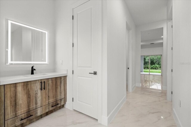 4528 Yorkshire Ln, Kissimmee, FL 34758 - corridor featuring light marble finish floors, a sink, and baseboards