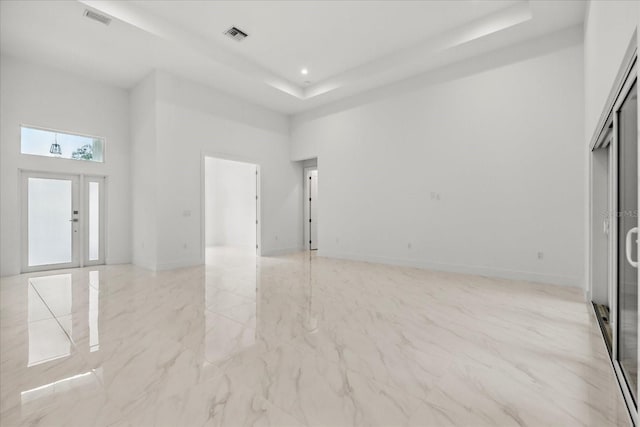 4528 Yorkshire Ln, Kissimmee, FL 34758 - spare room with a towering ceiling, a raised ceiling, light marble finish flooring, baseboards, and recessed lighting