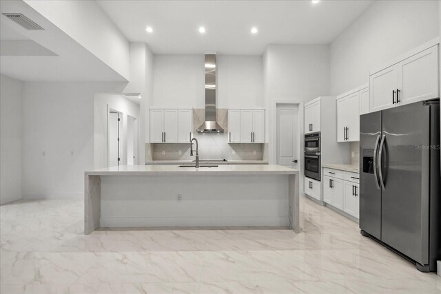 4528 Yorkshire Ln, Kissimmee, FL 34758 - kitchen with appliances with stainless steel finishes, light marble finish flooring, a towering ceiling, white cabinetry, and backsplash
