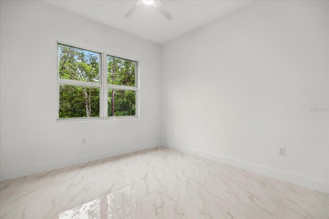 4528 Yorkshire Ln, Kissimmee, FL 34758 - unfurnished room with a ceiling fan, baseboards, and marble look tiles