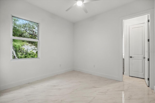 4528 Yorkshire Ln, Kissimmee, FL 34758 - unfurnished room with baseboards, ceiling fan, and light marble finish flooring