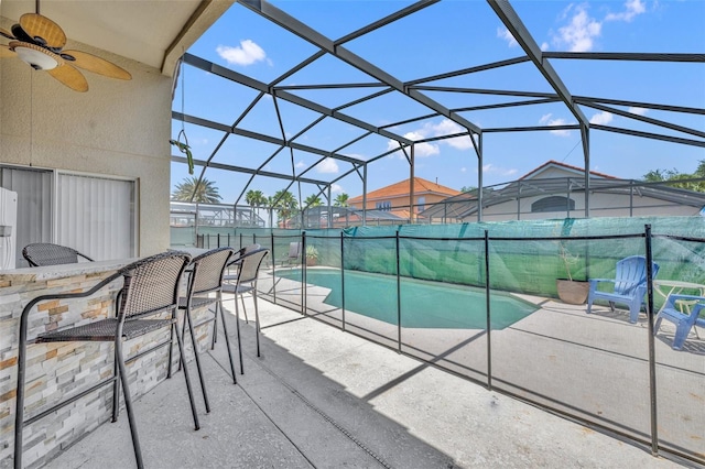 outdoor pool featuring a patio, a fenced backyard, a ceiling fan, and a lanai
