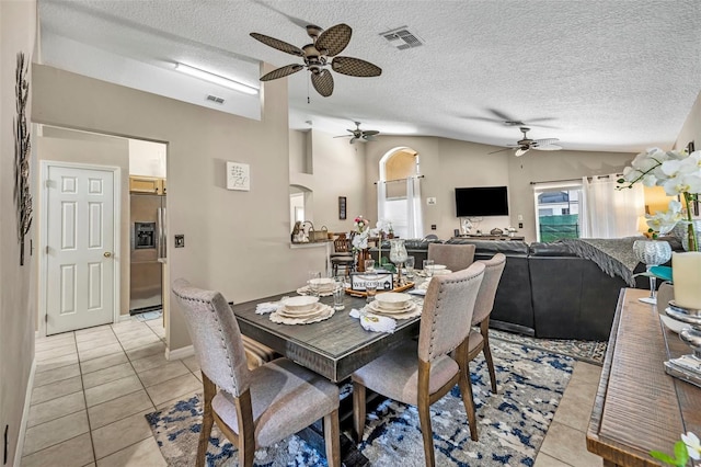 dining area with ceiling fan, light tile patterned floors, healthy amount of natural light, and a textured ceiling