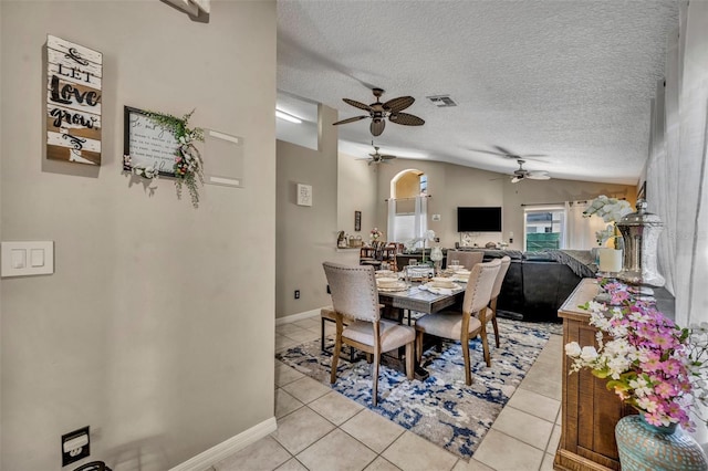 dining room featuring ceiling fan, light tile patterned flooring, a textured ceiling, and baseboards