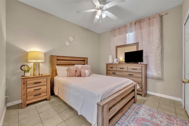 bedroom with light tile patterned flooring, baseboards, and ceiling fan
