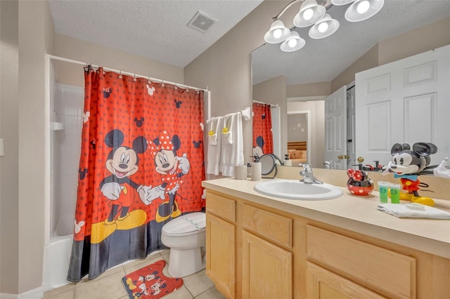 bathroom with toilet, tile patterned flooring, vanity, shower / tub combo, and a textured ceiling