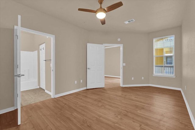unfurnished bedroom featuring light wood finished floors and baseboards