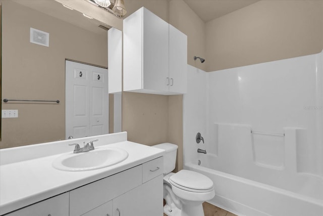 bathroom featuring toilet, vanity, and shower / washtub combination