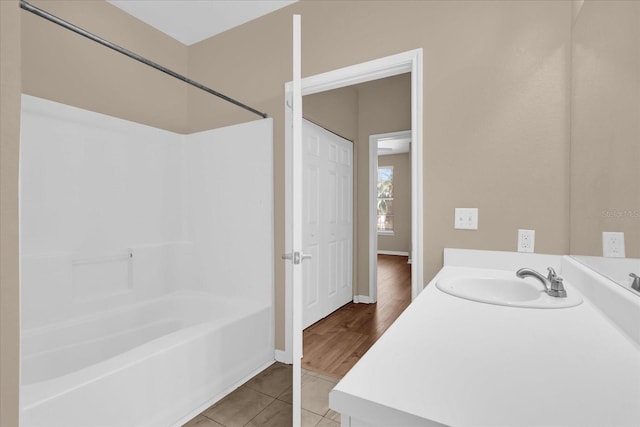 full bathroom featuring tile patterned floors,  shower combination, vanity, and baseboards