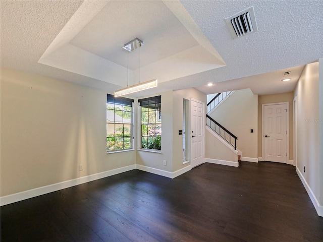 208 Frinton Cv, Longwood, FL 32779 - unfurnished living room with a raised ceiling, dark wood finished floors, stairs, baseboards, and a textured ceiling