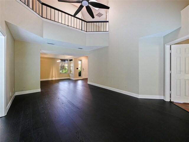 208 Frinton Cv, Longwood, FL 32779 - unfurnished living room with a ceiling fan, dark wood finished floors, baseboards, and a towering ceiling