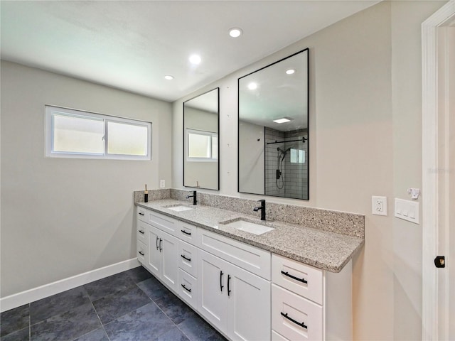 208 Frinton Cv, Longwood, FL 32779 - bathroom with double vanity, a tile shower, baseboards, and recessed lighting