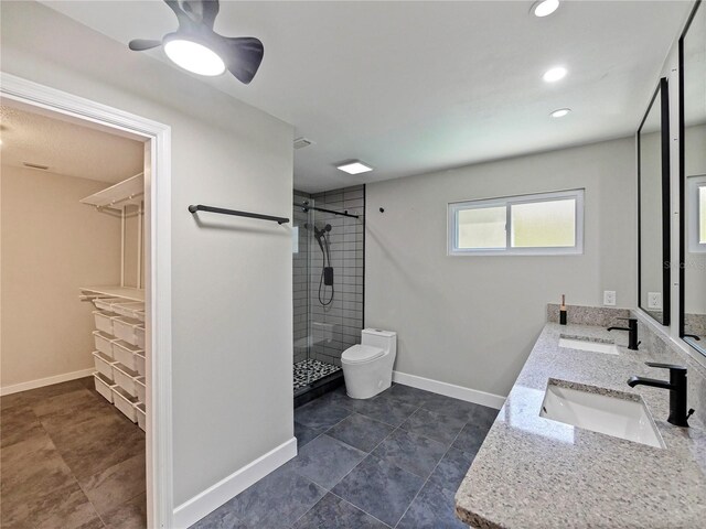 208 Frinton Cv, Longwood, FL 32779 - bathroom with a stall shower, a walk in closet, baseboards, double vanity, and toilet