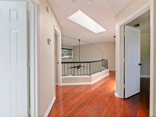 208 Frinton Cv, Longwood, FL 32779 - corridor with a skylight, wood finished floors, and baseboards