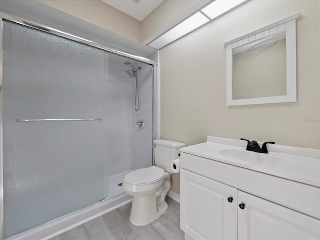 208 Frinton Cv, Longwood, FL 32779 - full bath with toilet, vanity, a stall shower, and wood finished floors