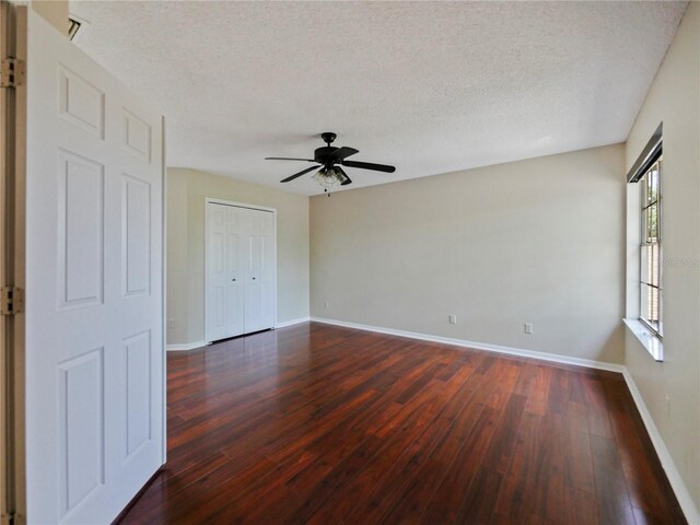 208 Frinton Cv, Longwood, FL 32779 - spare room with dark wood-style flooring, baseboards, a textured ceiling, and a ceiling fan