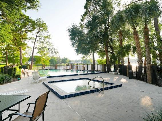 208 Frinton Cv, Longwood, FL 32779 - community pool with a patio and a hot tub