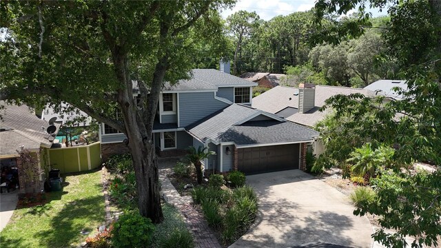 208 Frinton Cv, Longwood, FL 32779 - view of front of property with a shingled roof, a garage, driveway, and brick siding