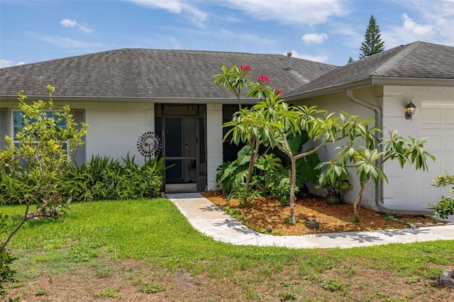 11811 Scarecrow Ln, Orlando, FL 32821 - view of front of home with a shingled roof, a front yard, and stucco siding