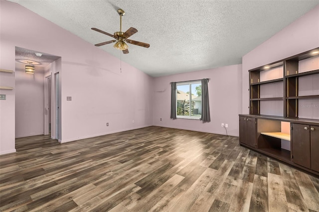 11811 Scarecrow Ln, Orlando, FL 32821 - unfurnished living room with a textured ceiling, vaulted ceiling, ceiling fan, and wood finished floors