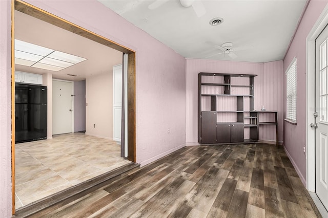 11811 Scarecrow Ln, Orlando, FL 32821 - unfurnished dining area featuring a ceiling fan, wood finished floors, and baseboards