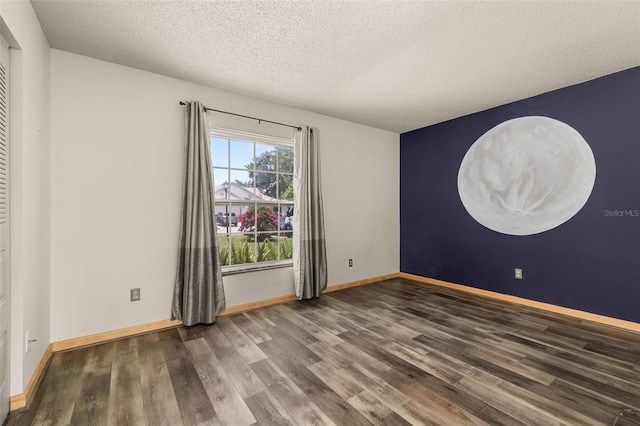 11811 Scarecrow Ln, Orlando, FL 32821 - unfurnished room featuring wood finished floors, a textured ceiling, and baseboards