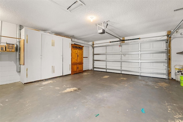 11811 Scarecrow Ln, Orlando, FL 32821 - garage featuring a garage door opener and concrete block wall