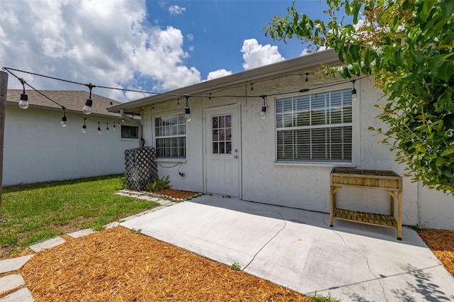 11811 Scarecrow Ln, Orlando, FL 32821 - entrance to property with stucco siding and a patio