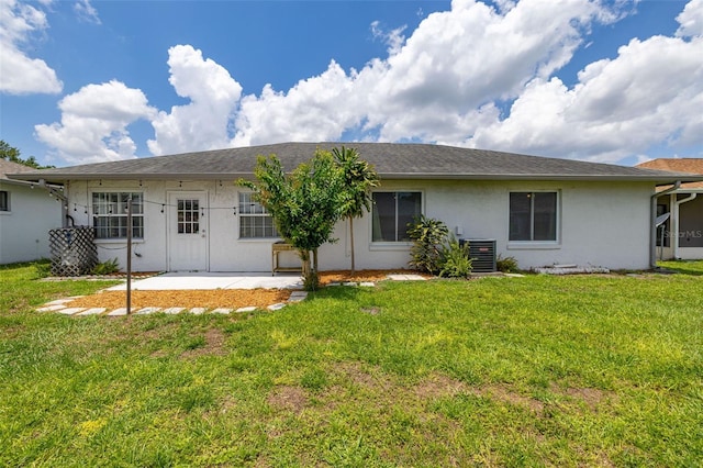 11811 Scarecrow Ln, Orlando, FL 32821 - rear view of house featuring stucco siding, a patio, a yard, and central air condition unit